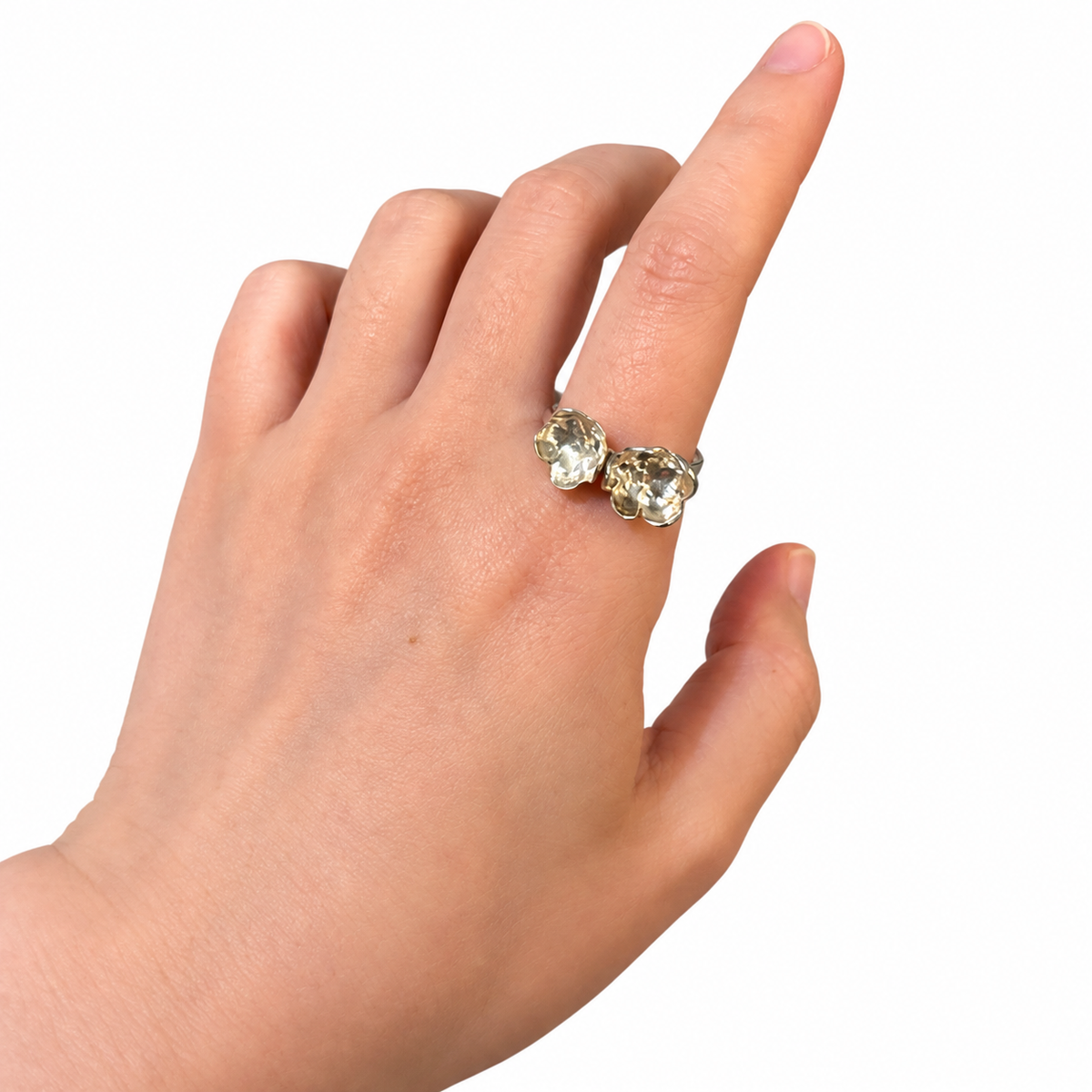 Twin Blossom fine silver ring worn on a hand against a white background